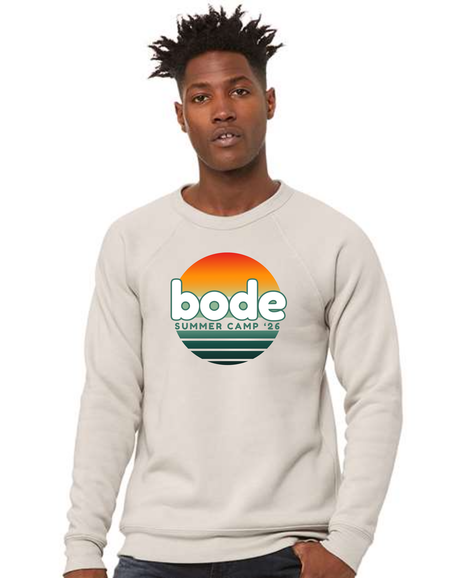A person wearing a light-colored designerapp Bode Summer Bootcamp "OG Logo" unisex crewneck fleece raglan sweatshirt (3901) with a sunset-inspired front graphic.