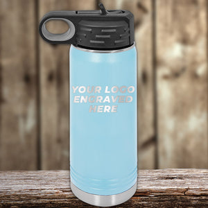 A light blue Kodiak Coolers insulated water bottle with a black lid features "YOUR LOGO ENGRAVED HERE" on the front—part of the 4th of July SALE: Custom Logo Drinkware, front engraving included, $200 minimum order. Perfect to pair with can holders.