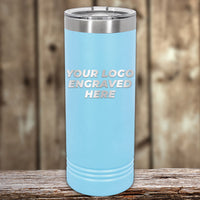 A light blue Kodiak Coolers travel tumbler with a metallic lid and front-engraved custom logo sits on a wooden surface, perfect for 4th of July SALE promos or as a unique addition to your personalized drinkware collection. $200 minimal order.