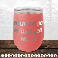 A Kodiak Coolers custom drinkware tumbler with pink insulation and the text "Your Logo Engraved Here" in silver is placed on a wooden surface. Below it are small icons of various colored custom mugs. A faint mountain background enhances its appeal as the perfect promotional gift, especially during our HUGE LABOR DAY SALE - ENDS TODAY!