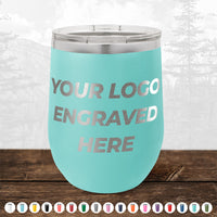 A turquoise Kodiak Coolers 12 oz stemless wine cup with your logo engraved, shown on wood with color options—perfect for those wanting custom engraved drinkware. No minimum order and sample volume pricing available.