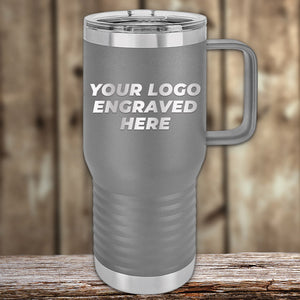 A gray Kodiak Coolers travel mug with handle and lid, engraved with your custom logo, sits on wood. From the 4th of July SALE—$200 minimum order. Stylish stainless steel drinkware by Kodiak Coolers.