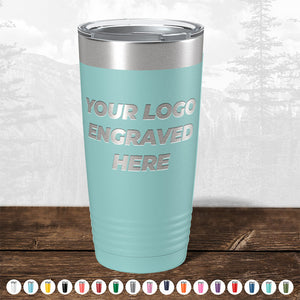 Kodiak Coolers offers custom stainless steel tumblers with laser-etched logos, showcased against a forest setting. Ideal for corporate gifts, these tumblers are available in various colors. No setup fees and limited time offer.