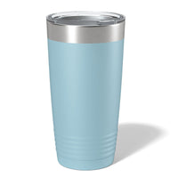 A light blue insulated tumbler from Kodiak Coolers with "your logo engraved here" text, ideal as a promotional gift, displayed on a wooden surface against a faded forest background.