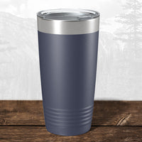A 20 oz Wisconsin Green Bay Bulldogs tumbler by Kodiak Coolers with a laser-engraved design and clear lid rests on wood—a stylish choice for school drinkware fans.