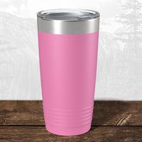 A 20 oz Wisconsin Green Bay Bulldogs tumbler by Kodiak Coolers, featuring a laser-engraved design and silver lid, sits on a wooden surface with a blurred mountain background.