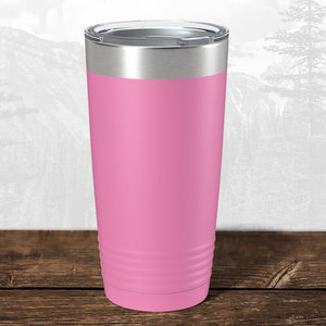 A Kodiak Coolers 20 oz Wisconsin Luxemburg Casco Spartans tumbler with a laser-engraved design and metal lid rests on wood, making it an ideal school drinkware gift or personalized mug, with a subtle mountain scene behind.