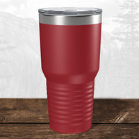 A Kodiak Coolers 30 oz red tumbler, laser engraved with the Wisconsin Luxemburg Casco Spartans school design and a clear plastic lid, sits on a wooden surface with a mountain background.