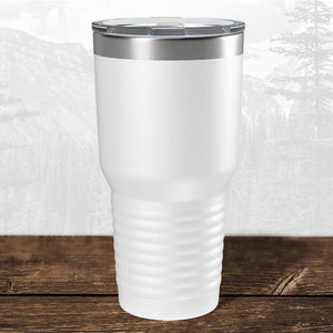 A Kodiak Coolers 30 oz tumbler with a laser-engraved Wisconsin Green Bay Bulldogs design sits on a wooden surface—ideal school drinkware for fans.