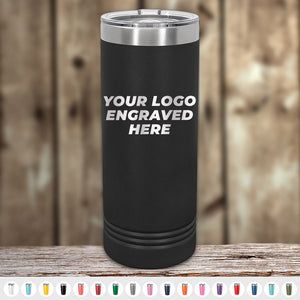 A black Kodiak Coolers tumbler with a custom front-engraved logo sits on a wooden surface—ideal as a promo gift. 4th of July SALE: Engraved Custom Logo Drinkware, $200 minimum order; color options shown below.