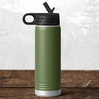 A Kodiak Coolers 20 oz water bottle with flip top straw, laser engraved with the Wisconsin Luxemburg Casco Spartans design, sits on wood with blurred mountains in the background, reflecting school pride and adventure.