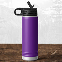 A Kodiak Coolers 20 oz water bottle with flip top straw, laser engraved for Wisconsin Green Bay Bulldogs fans, rests on wood; this school drinkware is perfect for Bulldog supporters and stands out against a blurred mountain backdrop.