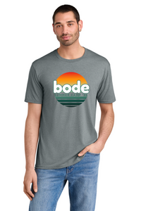 Man in blue jeans and a Printify 2026 Bode Summer Bootcamp OG Logo Unisex DM130 Tri Blend T-Shirt, featuring a sunset graphic and breathable, lightweight fabric.