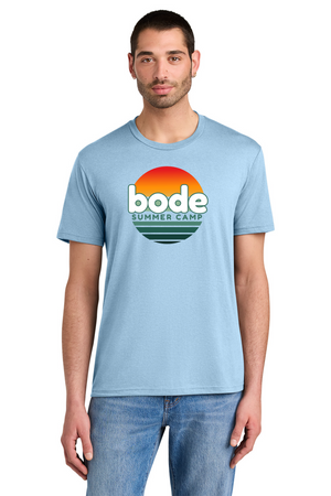 A man wears the Printify 2026 Bode Summer Bootcamp OG Logo Unisex T-Shirt DM130 Tri Blend in light blue, featuring a sunset logo and lightweight, breathable fabric, standing against a white background for casual comfort.