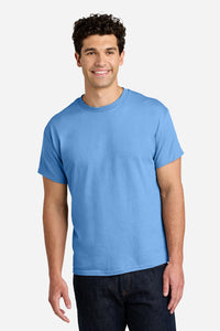 A man stands facing forward, smiling, wearing a Gildan 5000 Heavy 100% Cotton Custom T-Shirt (Pack of 36) with custom screen printed logo and dark jeans against a neutral background.