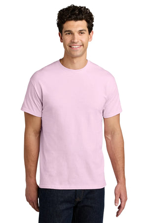 A man stands smiling in a plain white setting, wearing a light pink Gildan 5000 Heavy 100% Cotton Custom T-Shirt (Pack of 36) with screen printed logo, and dark jeans.