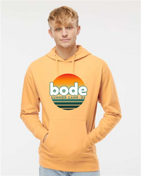 A young man wears a yellow Printify "2026 Bode Summer Bootcamp — OG Logo" unisex fleece hoodie (Independent Trading Co. SS4500) with an adjustable hood and front sunset graphic.