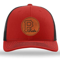 The designerapp Pulaski Reds Baseball Richardson 112 Snapback Trucker Cap features a leather patch with a large "P" and "Reds" logo on the front in red and black.