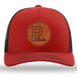 The designerapp Pulaski Reds Baseball Richardson 112 Snapback Trucker Cap features a leather patch with a large "P" and "Reds" logo on the front in red and black.