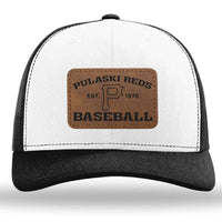 The designerapp Pulaski Reds Baseball Richardson 112 snapback trucker cap features a black and white design with a custom leather patch reading "Pulaski Reds Est. 1978 Baseball" and a bold "P" in the center.