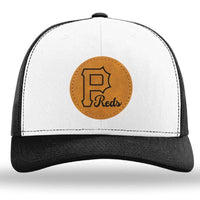 The designerapp Pulaski Reds Baseball Richardson 112 snapback trucker cap features a black and white design with a brown leather patch showing a large "P" and "Reds" in cursive below.