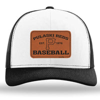 The designerapp Pulaski Reds Baseball Richardson 112 snapback trucker cap is a white and black hat with a custom leather patch reading "Pulaski Reds Baseball Est. 1978" and a large "P" in the center.