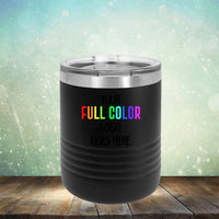 A black *Custom UV Printed Drinkware - Single Side Printing Included in Price* from *Kodiak Coolers* with a transparent lid features the text "Your Full Color Logo Goes Here" in rainbow colors. The background is a bokeh effect with light spots and a wooden surface.