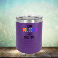 A purple, insulated tumbler with a clear lid. "Your Full Color Logo Goes Here" is printed on the side in rainbow colors against a background with a bokeh effect. These Kodiak Coolers Custom UV Printed Drinkware - Single Side Printing Included in Price tumblers are perfect for showcasing your brand with style.