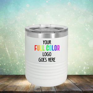 White insulated tumbler with a silver lid on a wooden surface, featuring the text "Your Full Color Logo Goes Here" against a blurred light blue and green background with bokeh effect. Perfect for those seeking high-quality tumblers ideal for customization with your engraving. Introducing the Custom UV Printed Drinkware - ONE TIME SPECIAL OFFER by Kodiak Coolers.