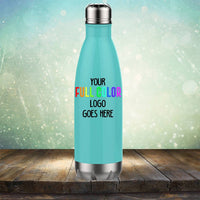 A blue insulated water bottle on a wooden surface with the text "Custom UV Printed Drinkware - ONE TIME SPECIAL OFFER" by Kodiak Coolers printed on it. The background has a light bokeh effect, giving the scene an appealing touch that complements other branded items like tumblers and coffee mugs.