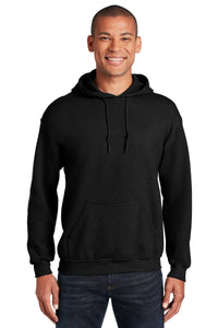 A person is standing and smiling, wearing blue jeans and a Gildan Heavy Blend™ Hooded Sweatshirt 18500 (Pack of 36) with custom screen printed logo, against a white background.