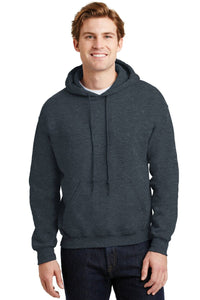 A young man stands facing forward in a dark gray Gildan Heavy Blend™ Hooded Sweatshirt 18500 with a custom screen printed logo, paired with dark jeans, against a neutral background. Product sold as a pack of 36.