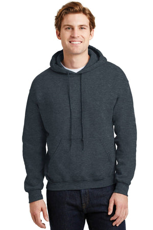 A young man stands facing forward in a dark gray Gildan Heavy Blend™ Hooded Sweatshirt 18500 with a custom screen printed logo, paired with dark jeans, against a neutral background. Product sold as a pack of 36.