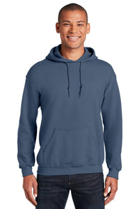 A person wearing a blue Gildan Heavy Blend™ Hooded Sweatshirt 18500 (Pack of 36) with custom screen printed logo, front pocket, and drawstrings stands smiling against a plain background.