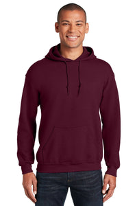 A person models a plain maroon Gildan Heavy Blend™ Hooded Sweatshirt (Pack of 36, style 18500) with custom screen printed logo and dark jeans, smiling at the camera against a white background.