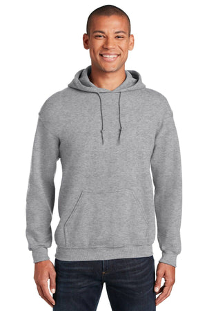 A person wearing a plain gray Gildan Heavy Blend™ 18500 hoodie, featuring a front pocket and drawstrings, smiles at the camera. This pack of 36 sweatshirts includes custom screen printed logos for sustainable comfort and style.