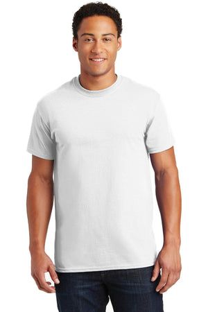 A man wearing a plain white Gildan - 100% US Cotton T-Shirt 2000 and blue jeans stands facing forward against a plain background, making an ideal image for promotional materials.