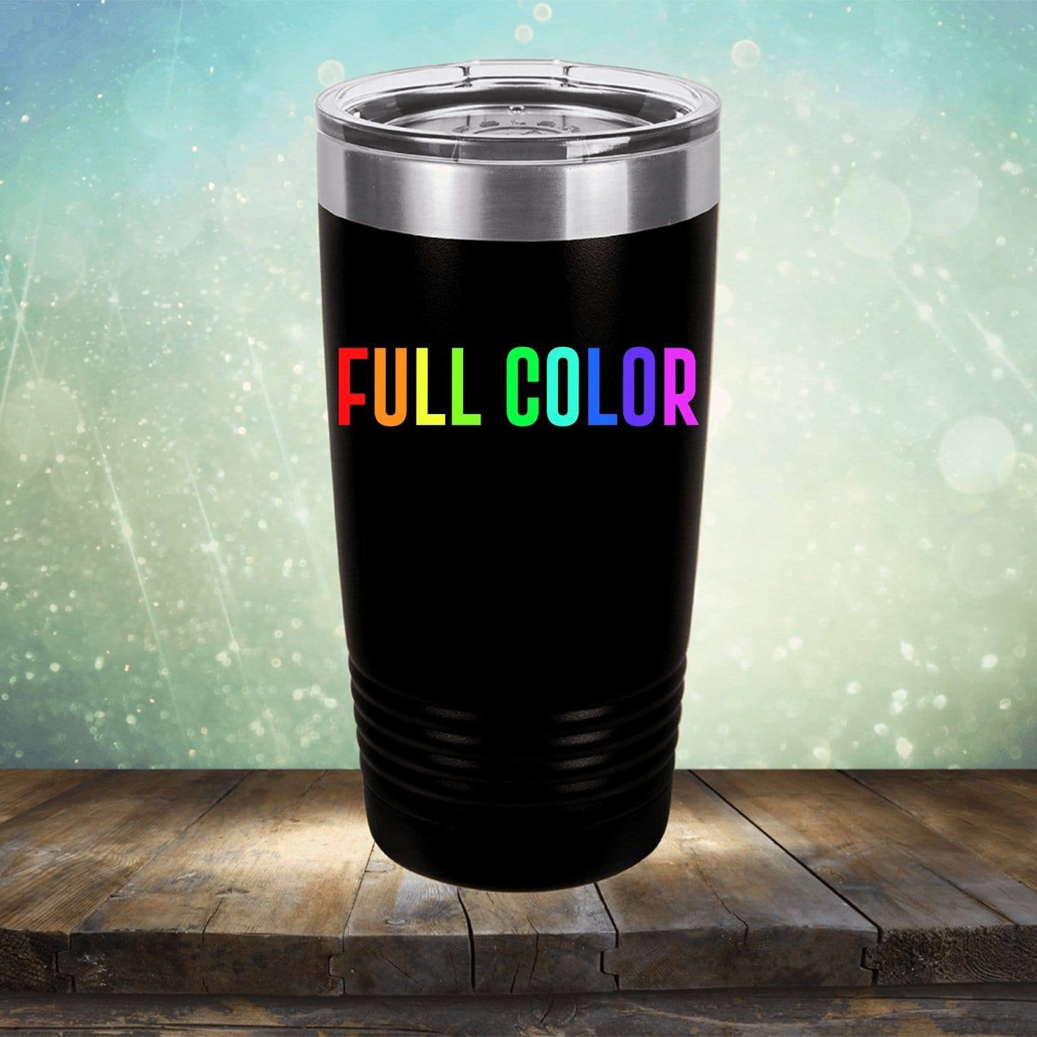 A black travel tumbler with a stainless steel lid stands on a wooden surface, featuring the words "FULL COLOR" in a rainbow gradient. The background is a gradient of blue and green with light bokeh, making it perfect for those who love Kodiak Coolers' Custom UV Printed Drinkware - Single Side Printing Included in Price.