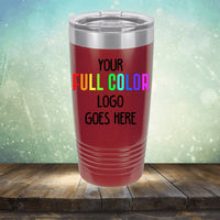 A Custom UV Printed Drinkware - Single Side Printing Included in Price with a red body and a clear lid, placed on a wooden surface. The text on the drinkware reads, "Your full color logo goes here." Ideal for customized tumblers or personalized coffee mugs from Kodiak Coolers.