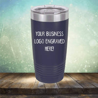 A Kodiak Coolers Custom Logo 20 oz Tumbler - SPECIAL OFFER - Front side Logo Included displayed against a wooden surface and a light, bokeh background. Ideal as personalized drinkware or a promotional gift.