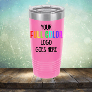 A pink tumbler with a silver lid is displayed on a wooden surface with a blurred, colorful background. The **Kodiak Coolers Custom UV Printed Drinkware - Single Side Printing Included in Price** has text stating, "Your full color logo goes here.