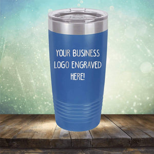 Blue **Custom Logo 20 oz Tumblers - SPECIAL OFFER - Front side Logo Included** by **Kodiak Coolers** with "Your Business Logo Engraved Here!" text, placed on a wooden surface with a blurred background—a perfect promotional gift for showcasing personalized drinkware to your clients.