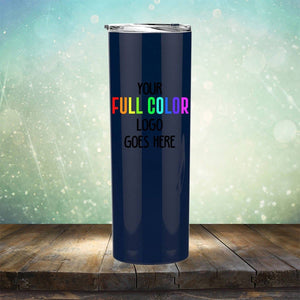 A navy-blue tumbler with the text "YOUR FULL COLOR LOGO GOES HERE" in rainbow letters on it, placed on a wooden surface with a blurred, light-filled background. The Kodiak Coolers Custom UV Printed Drinkware - ONE TIME SPECIAL OFFER is perfect for showcasing your brand and stands out among other coffee mugs with its vibrant design.