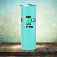 A light blue tumbler with a silver lid stands on a wooden surface. The text on the tumbler reads "Your full color logo goes here" in black and multi-colored lettering. The background is a sparkling gradient, making this Kodiak Coolers Custom UV Printed Drinkware - ONE TIME SPECIAL OFFER one of the most eye-catching tumblers available for custom engraving.