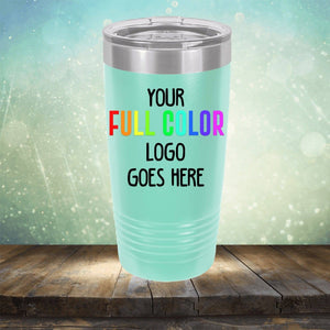 A light green Custom UV Printed Drinkware - Single Side Printing Included in Price with a steel lid labeled "Kodiak Coolers" placed on a wooden surface with a soft-focus background.