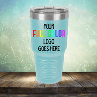 A light blue Custom UV Printed Drinkware - Single Side Printing Included in Price with a stainless steel lid is shown. The text on the drinkware reads, "YOUR FULL COLOR LOGO GOES HERE" with "FULL COLOR" in rainbow colors. The background features a blurred light effect. These customized tumblers from Kodiak Coolers are perfect for showcasing your brand in style.