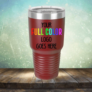 A Custom UV Printed Drinkware - ONE TIME SPECIAL OFFER from Kodiak Coolers with a ridged grip, featuring text that reads, "Your full color logo goes here," against a blurred background. This versatile piece can also be customized with engraving for an added personal touch.