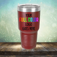 A maroon stainless steel tumbler with a ridged grip and metal lid displaying the text "Custom UV Printed Drinkware - Single Side Printing Included in Price" in a gradient of red, orange, yellow, green, blue, and purple. This customized tumbler from Kodiak Coolers is perfect for showcasing your brand in vibrant style.