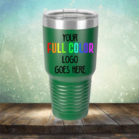 Green tumbler with a shiny metallic rim placed on a wooden surface, featuring the text "Your Full Color Logo Goes Here" in multicolored letters. Ideal for those seeking customized tumblers that add a personal touch to any setting, the Kodiak Coolers Custom UV Printed Drinkware - Single Side Printing Included in Price is the perfect choice.