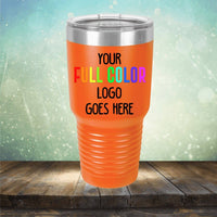 Orange travel tumbler with text "Custom UV Printed Drinkware - ONE TIME SPECIAL OFFER by Kodiak Coolers" stands on a wooden surface against a blurred background with light bokeh effects, perfect for those who love personalized tumblers.